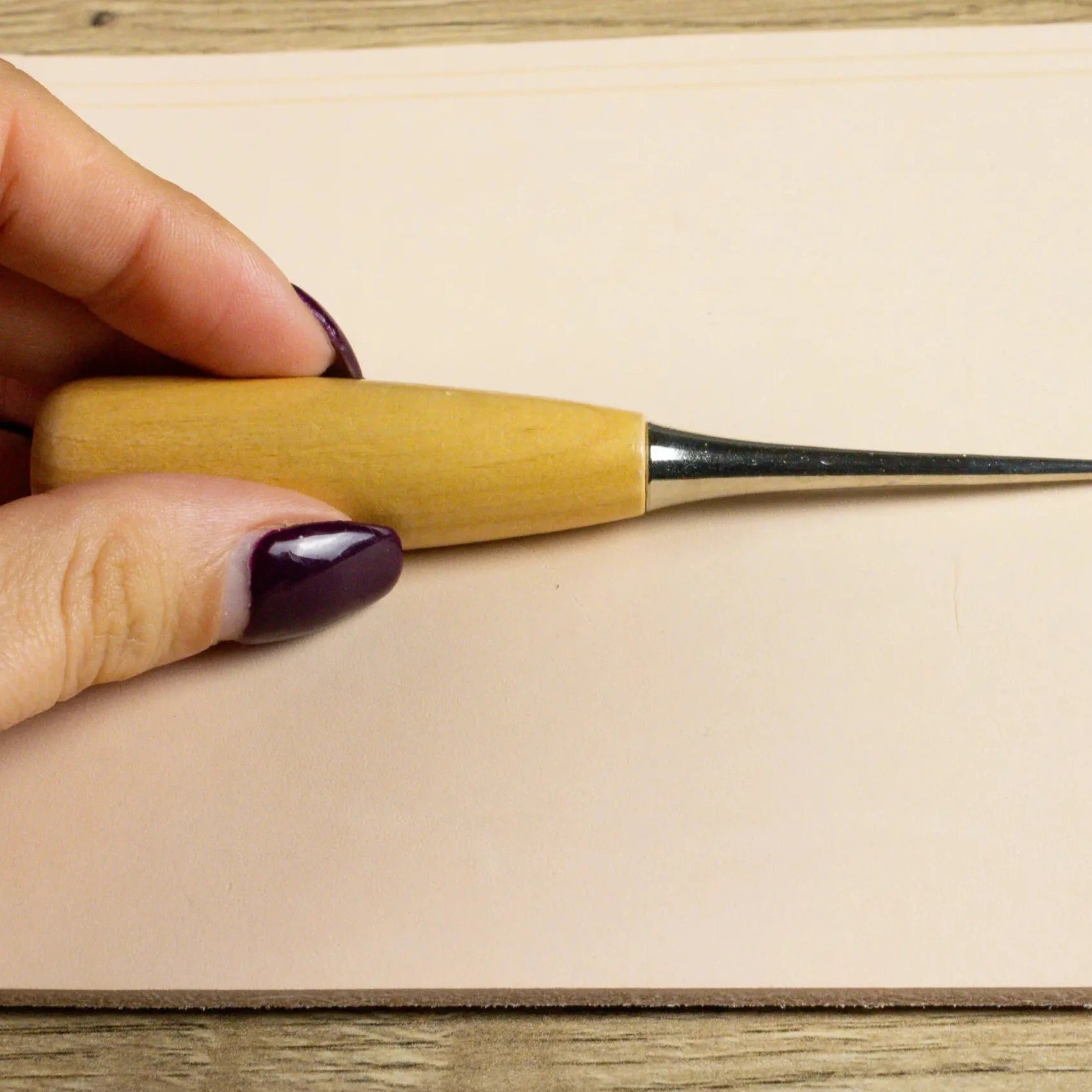 Someone holding the Leather Crafting Awl