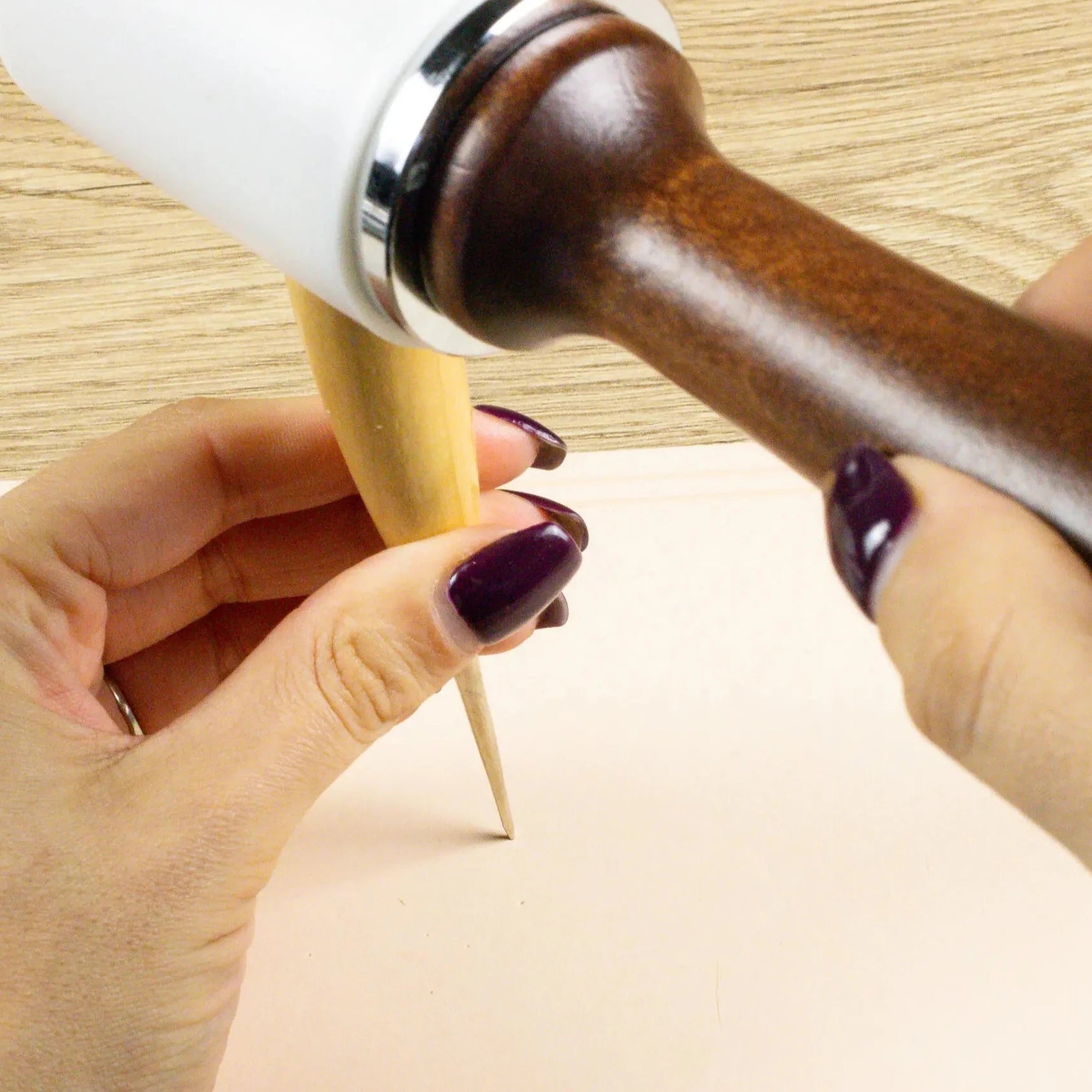 Someone using the Leather Crafting Awl