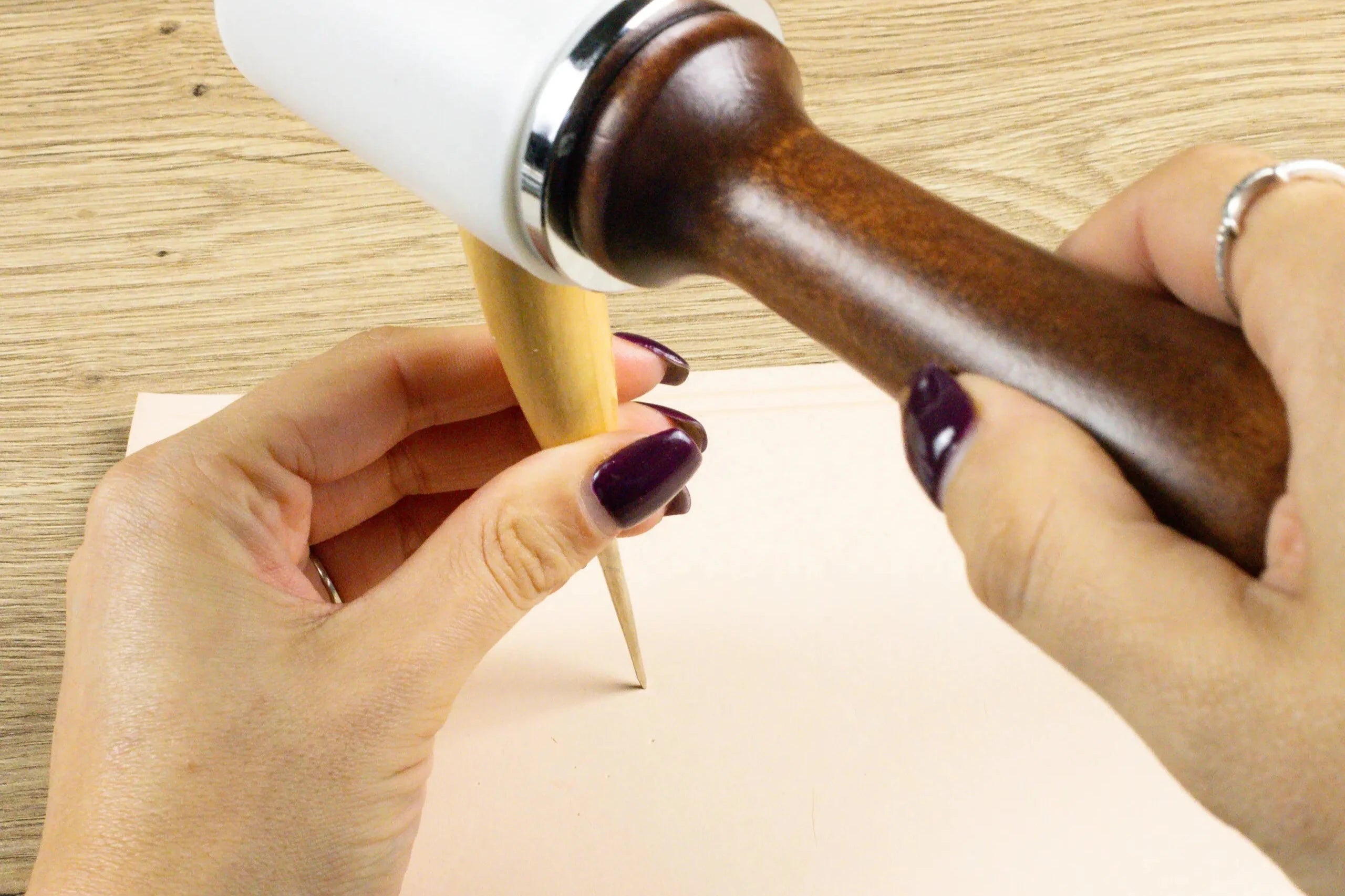 Someone using the Leather Crafting Awl