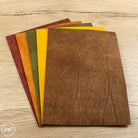 Set of brown leather sheets on a wooden surface
