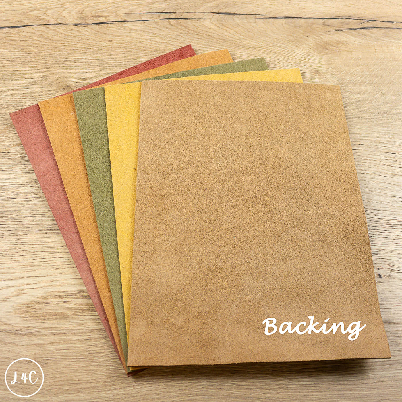 Set of brown paper sheets on a wooden surface with 'Backing' text.