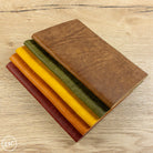 Set of leather samples in various colors on a wooden surface