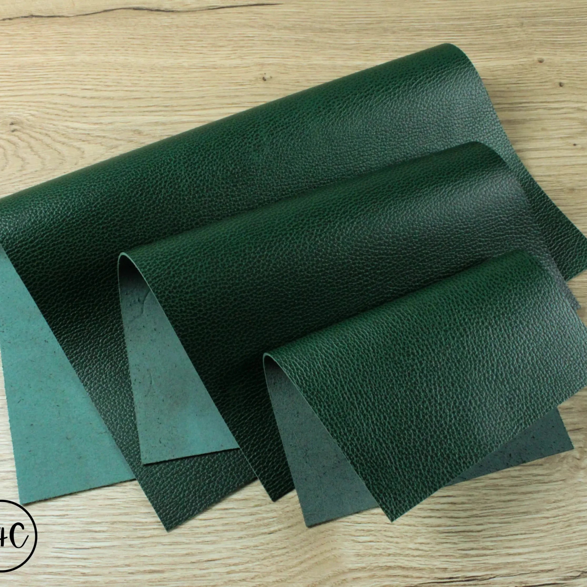 Evergreen Embossed Textured Grain Leather folded up on a nice wooden table