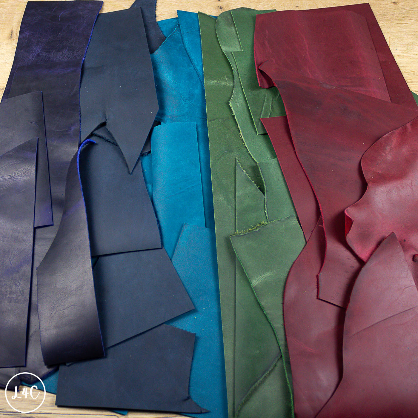 Colorful crazy horse leather arranged on a wooden surface.