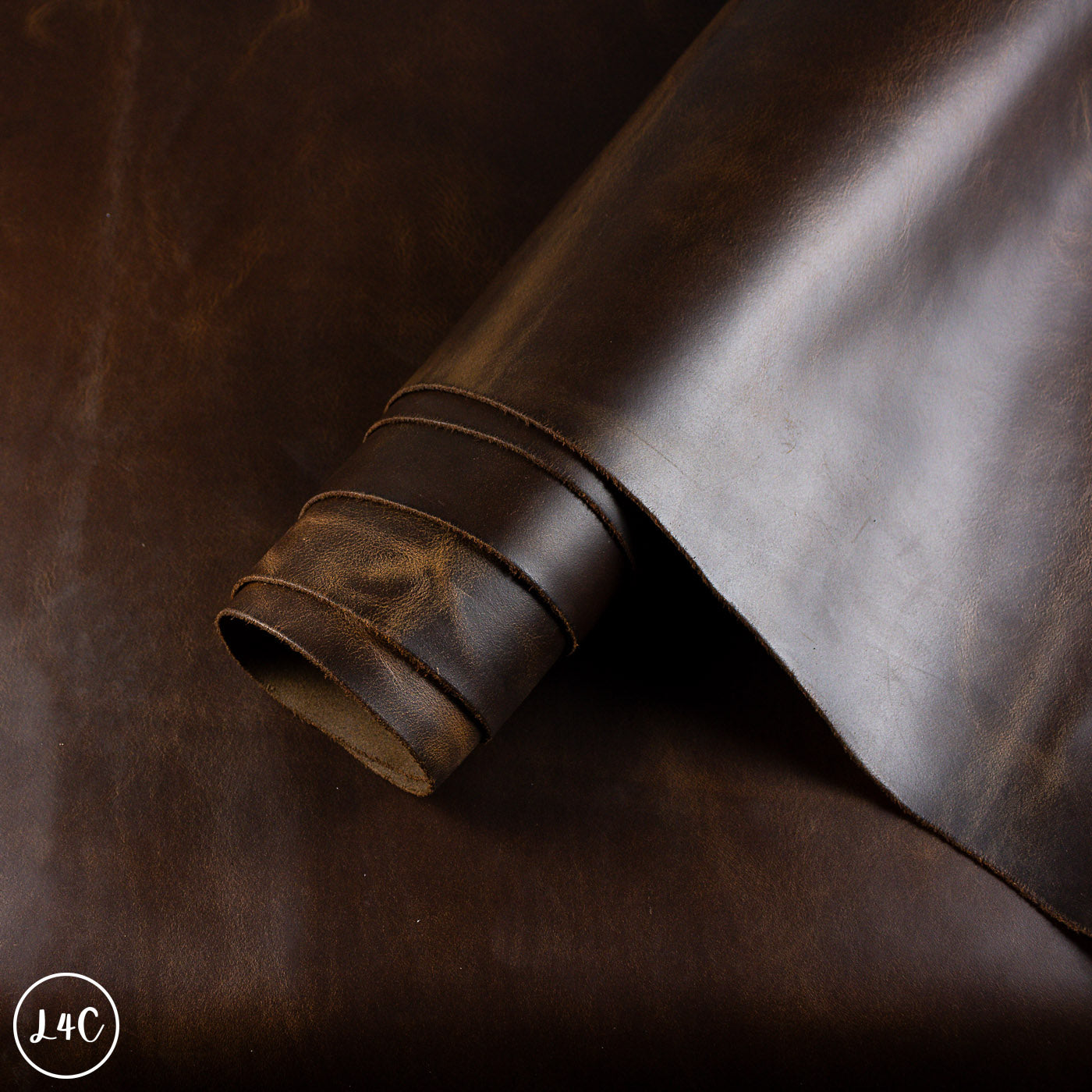 Close-up of a roll of dark brown leather with visible texture.