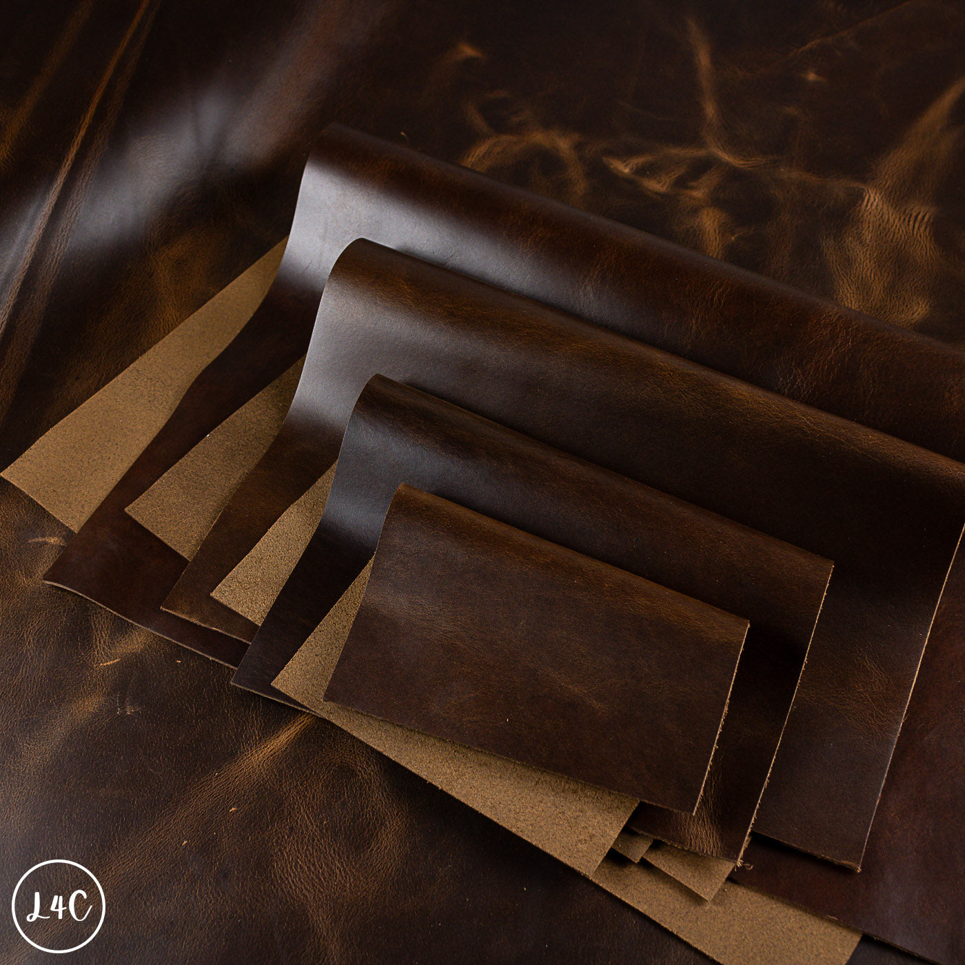Stack of dark brown leather panels on a textured surface