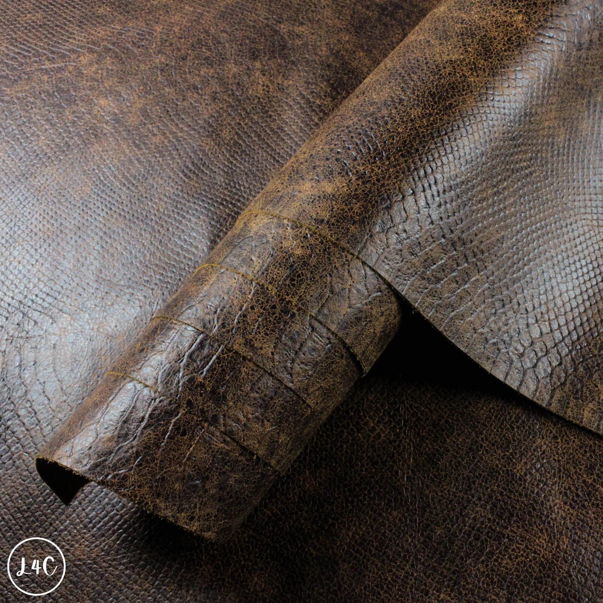 Distressed Antique Brown, Snake Print Textured Leather close up rolled