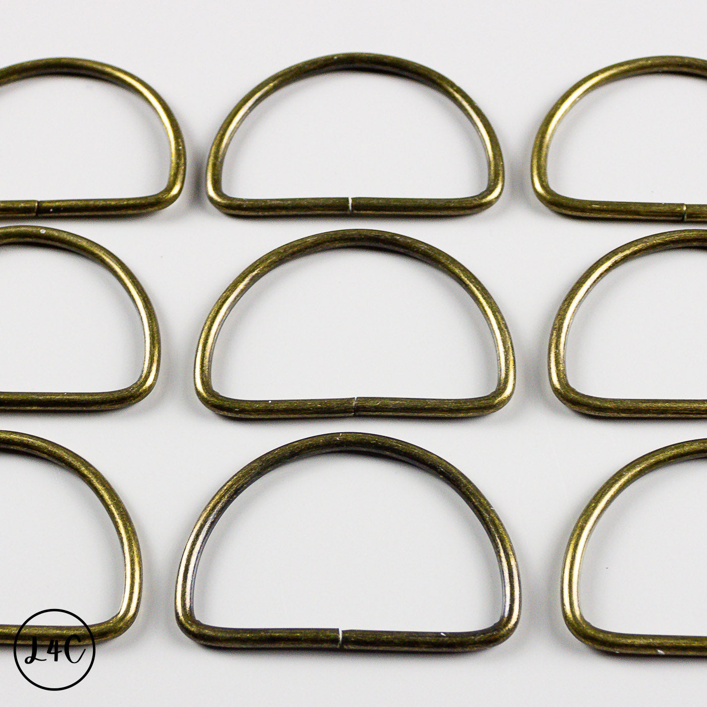 Bronze metal rings arranged in a grid on a white background