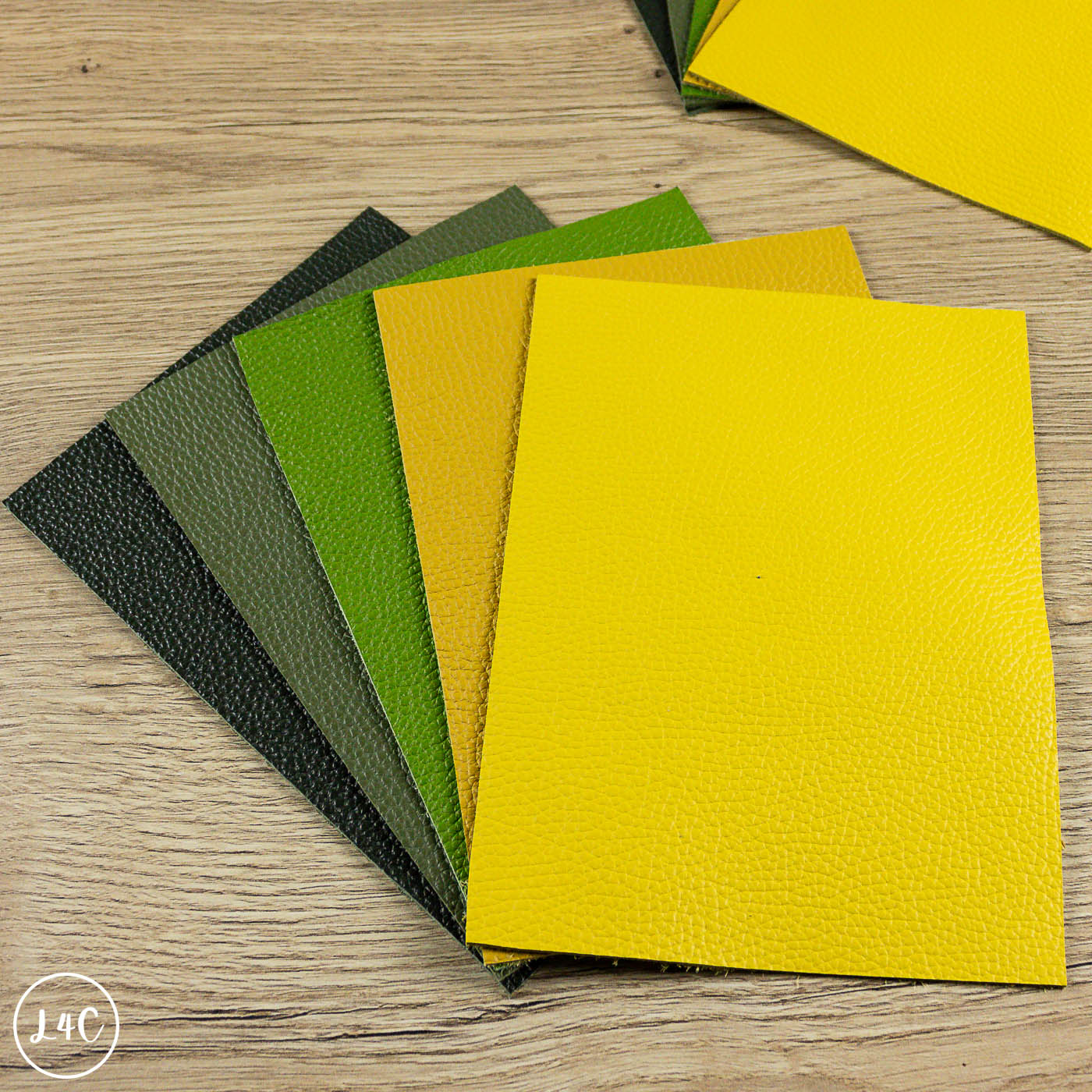 Collection of textured fairground leather panels in various colors on a wooden surface