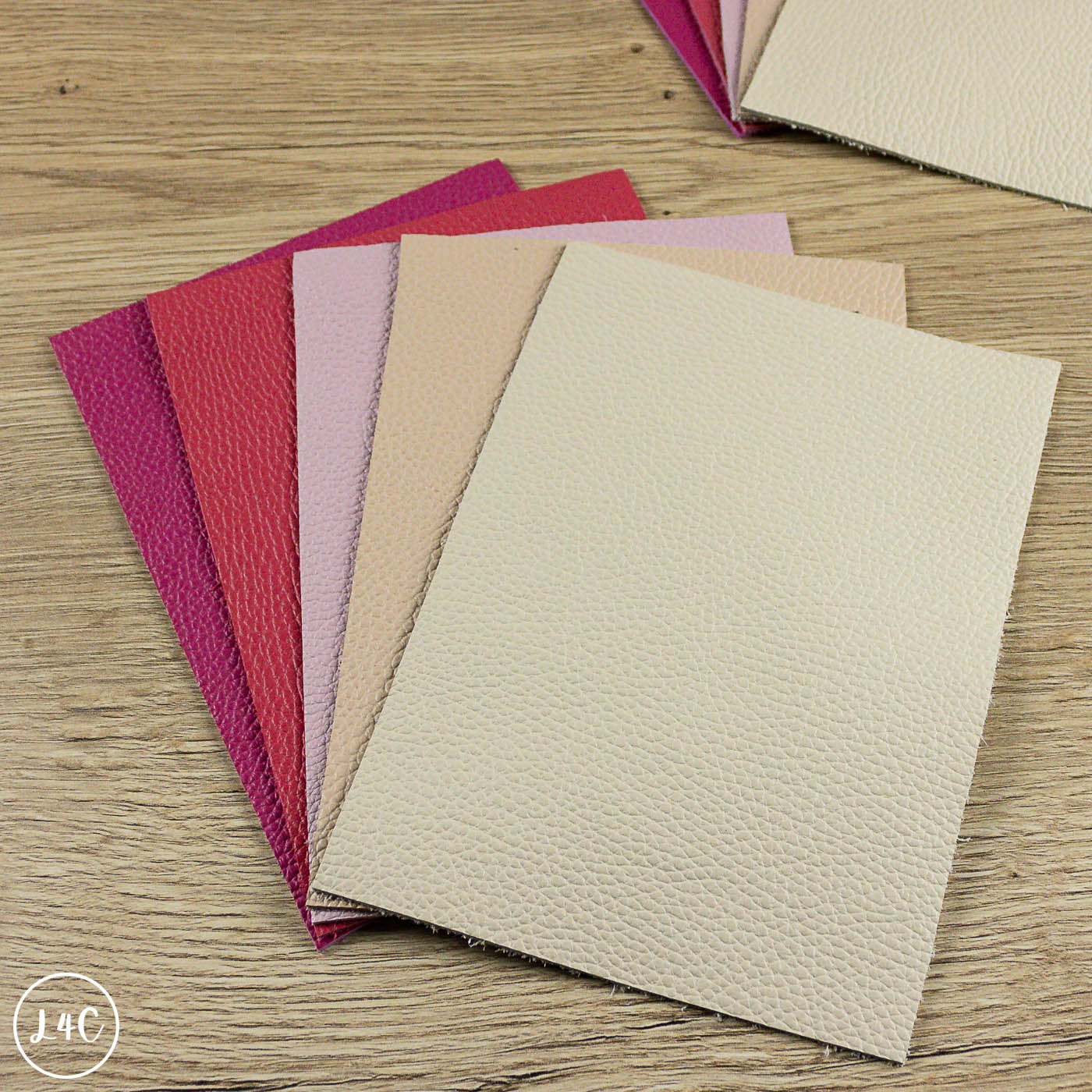 Collection of textured fairground leather panels in various colors on a wooden surface