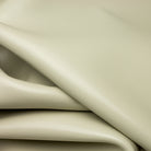 Close-up of beige leather with folds