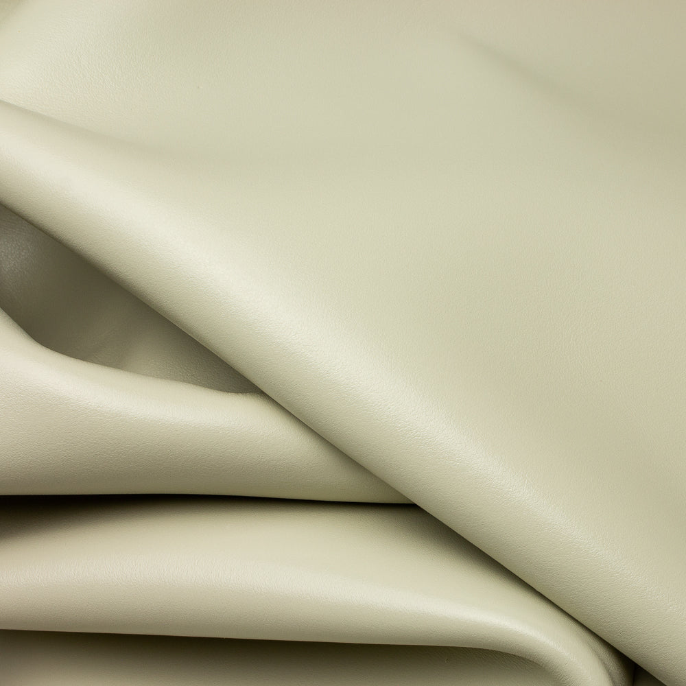 Close-up of beige leather with folds