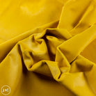 Close-up of yellow leather with visible hair texture