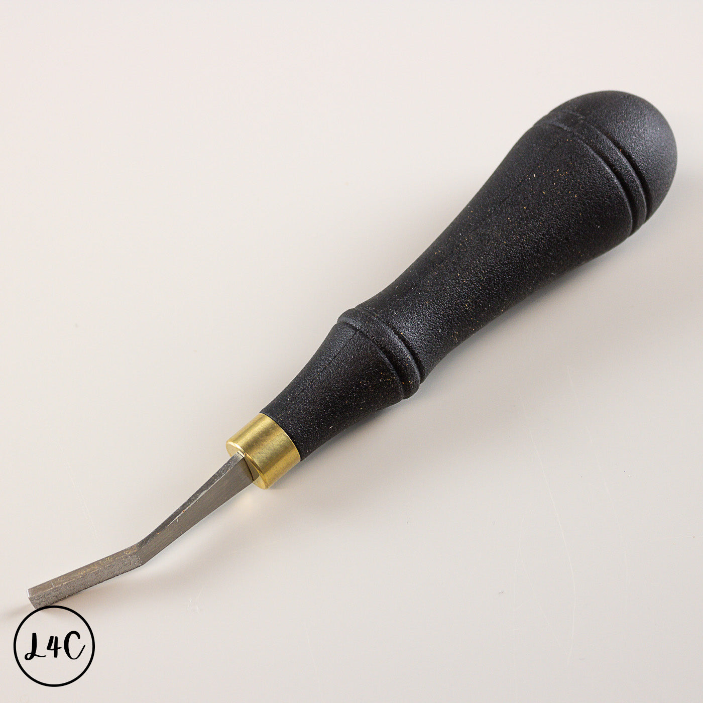 Black leather tool with gold accent on a white background