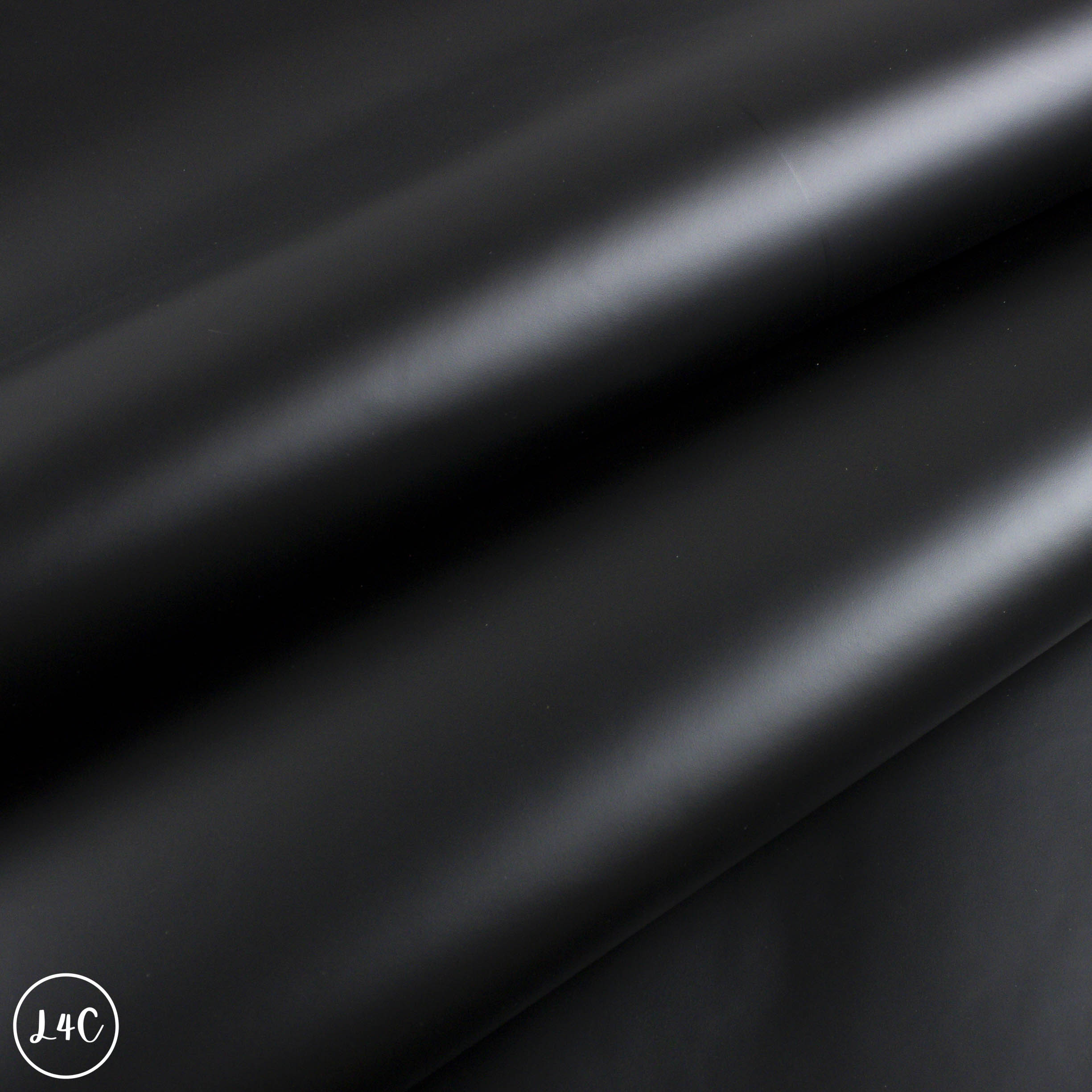 Close-up of black leather fabric with a subtle texture