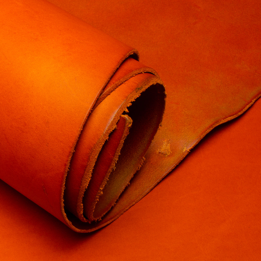 Close-up of orange leather with a visible grain texture