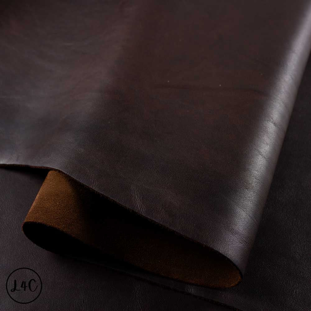 Dark brown leather fabric with a subtle texture on a dark background