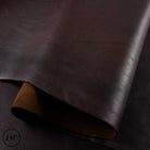 Dark brown leather fabric with a subtle texture on a dark background