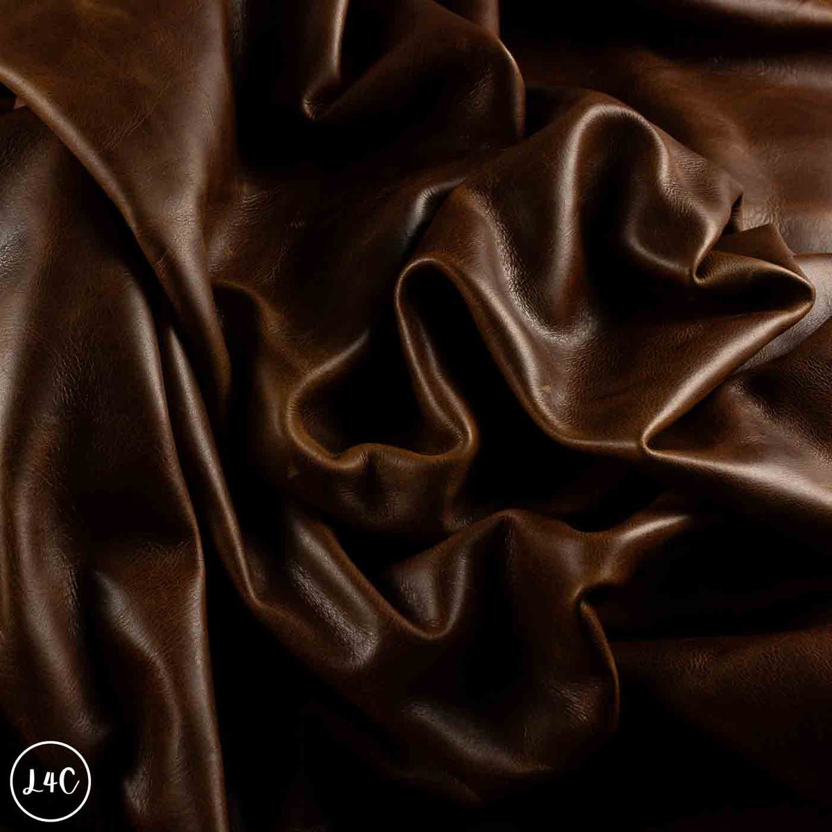 Dark brown draped leather with a smooth, glossy texture and soft folds