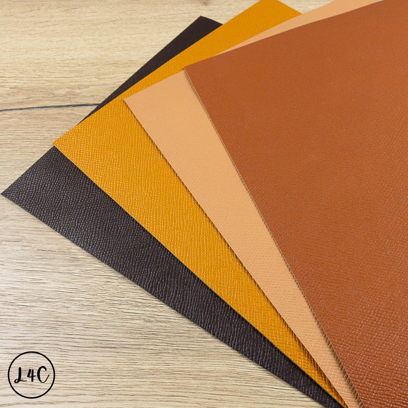 Collection of leather samples in various colors on a wooden surface