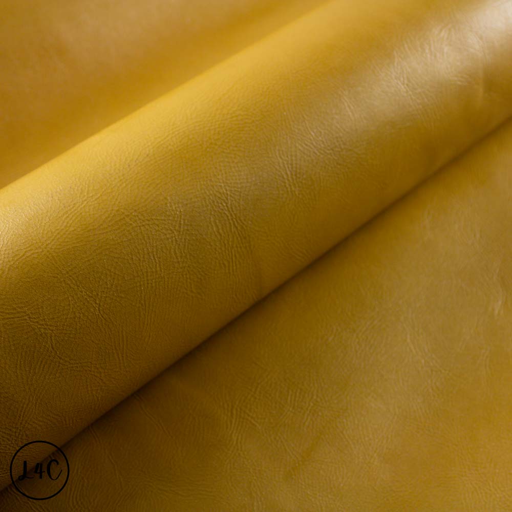 Close-up of yellow leather fabric with a subtle texture