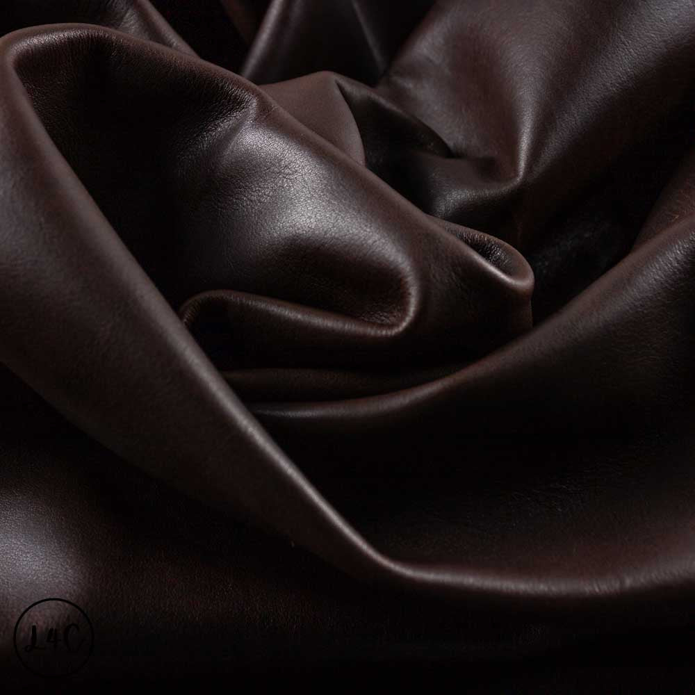 Close-up of dark brown leather fabric with folds