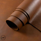 Rolled-up piece of brown leather with visible texture.
