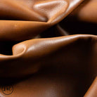 Close-up of brown leather texture showing folds