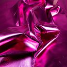 Close-up of pink metallic fabric with folds