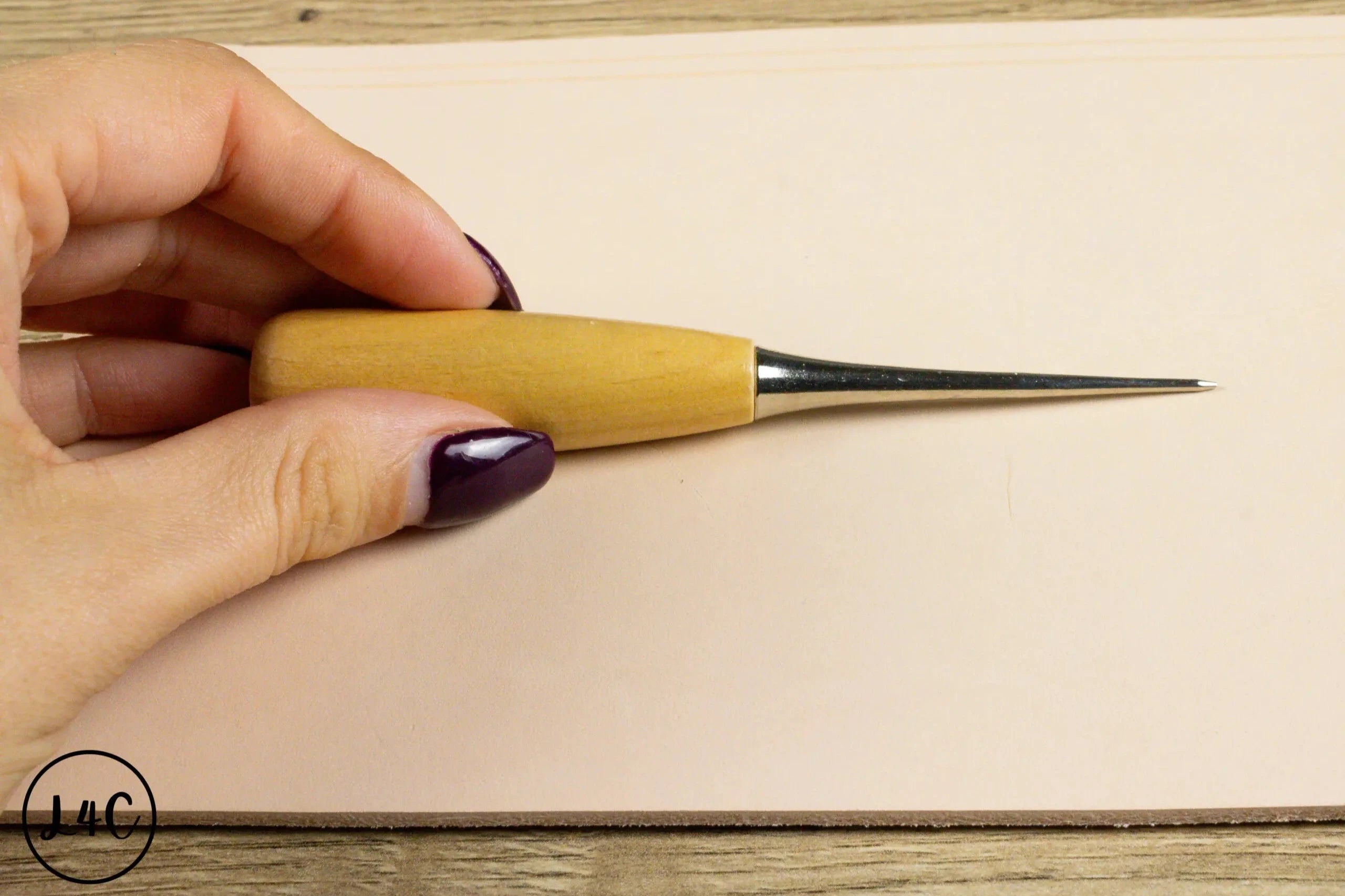 Someone holding the Leather Crafting Awl