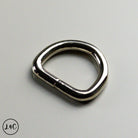 Metal D-ring on a gray background