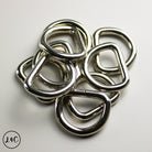 Stack of metal D-rings on a light gray background