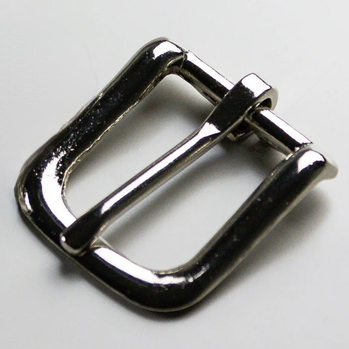 Metallic belt buckle on a light gray background