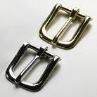 Gold and silver metal buckles on a white background