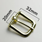 Gold metal buckle with measurements on a white background