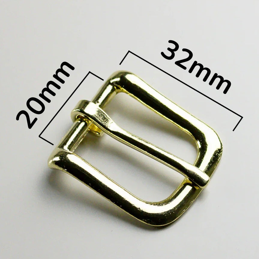Gold metal buckle with measurements on a white background