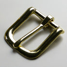 Gold metal buckle on a light gray background