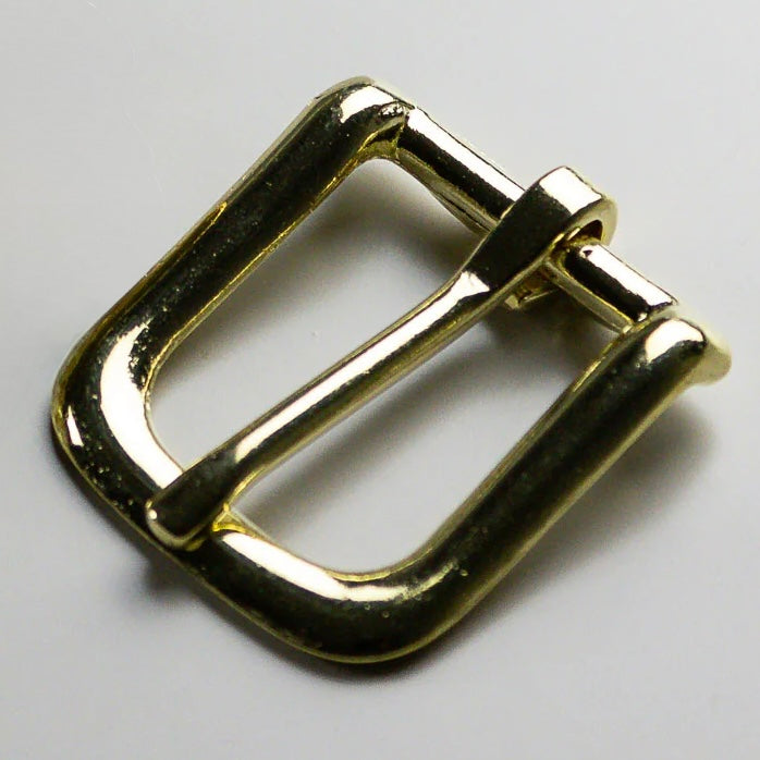 Gold metal buckle on a light gray background
