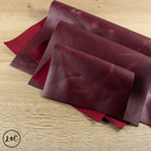 Red crazy horse leather sheets on a wooden surface