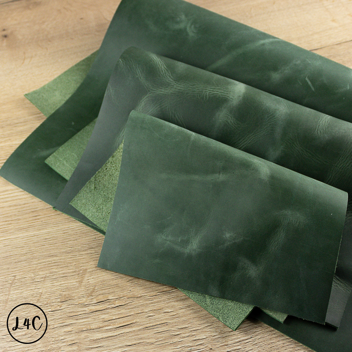 Green fern crazy horse leather panels on a wooden surface