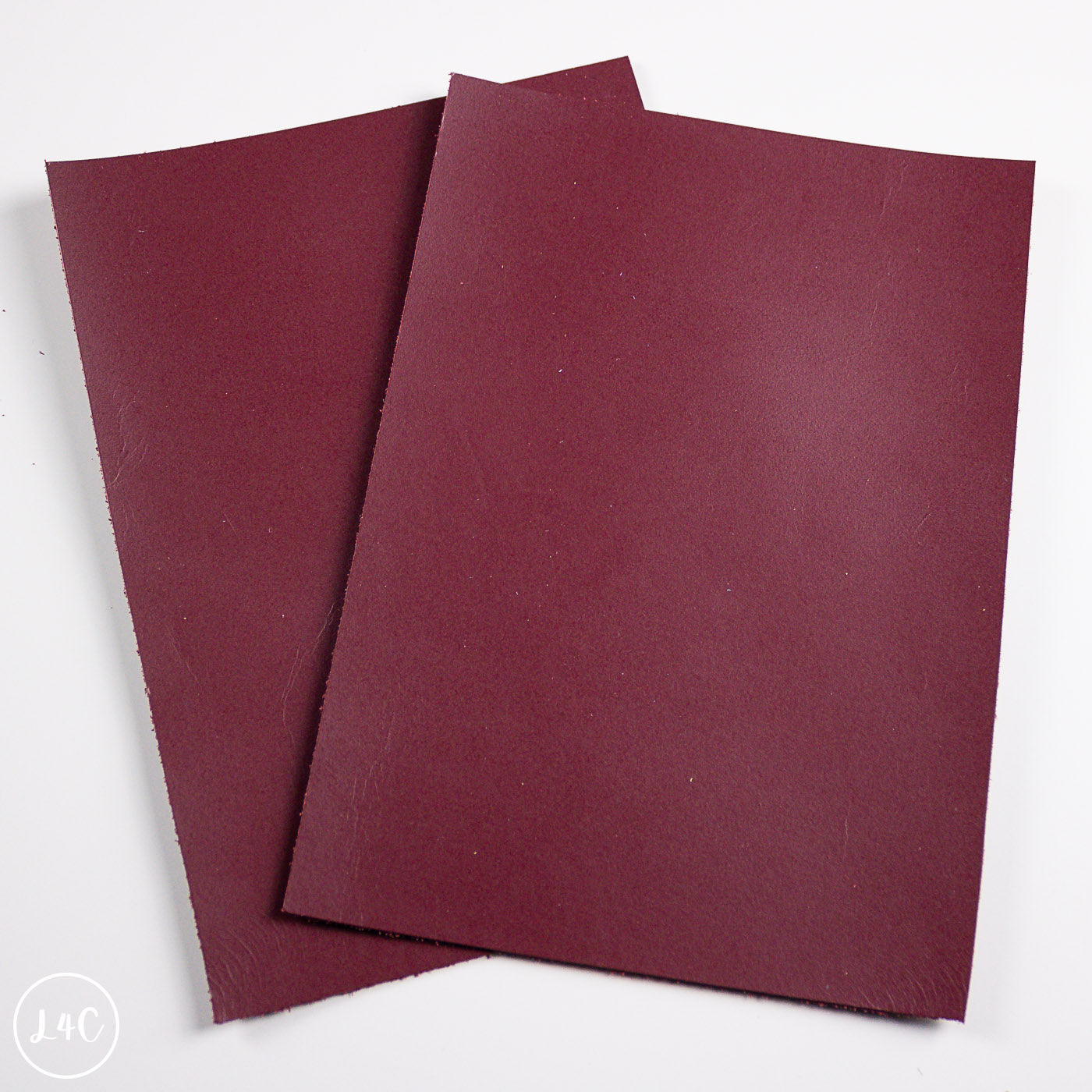 Two burgundy leather panels on a white background