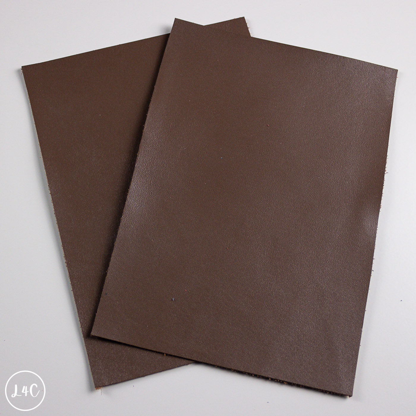 Two brown calf leather panels on a white background