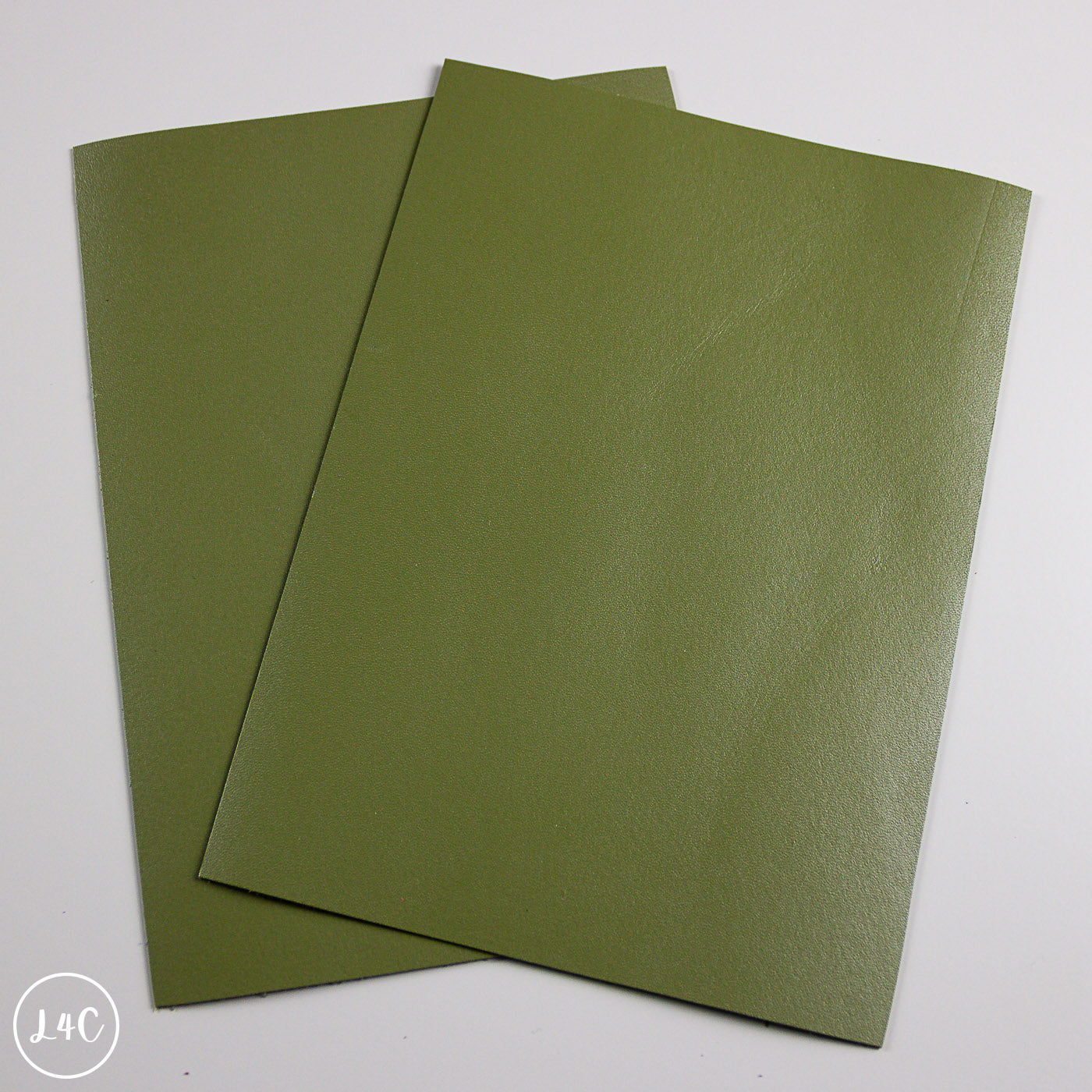 Two green calf leather panels on a white background