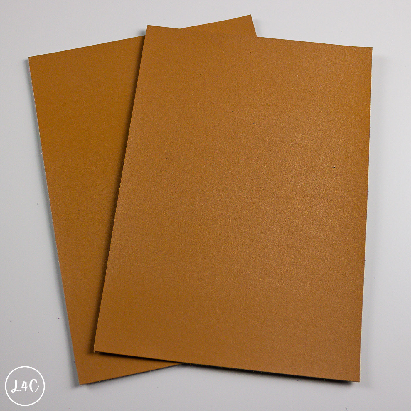 Two Tan calf leather panels on a white background
