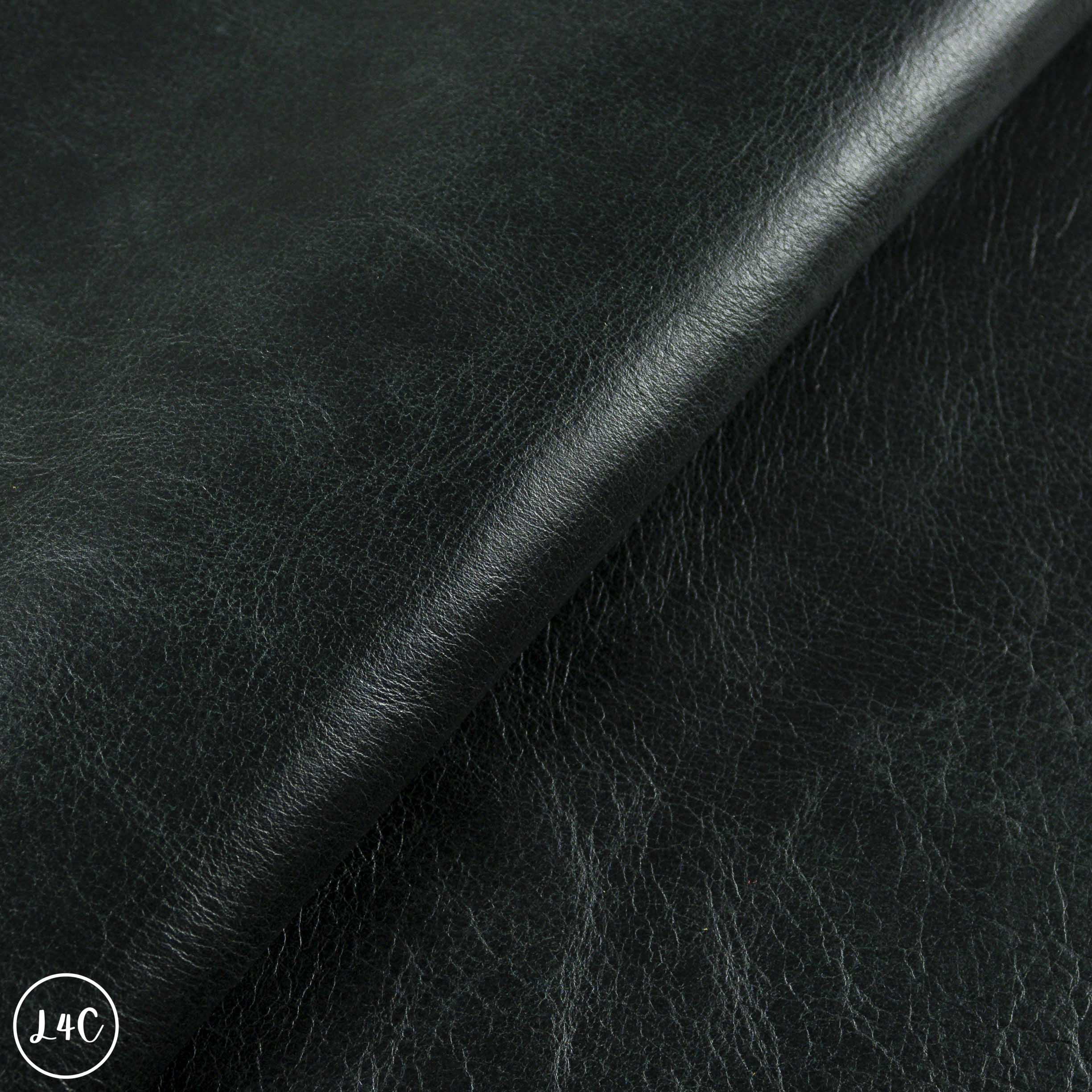 Close-up of dark green leather fabric with visible texture