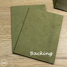 Two green country soft leather panels on a wooden surface with 'Backing' text.