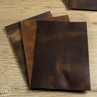 Three pieces of dark brown leather on a wooden surface with Leather4Craft branding.