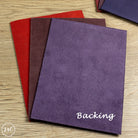 Purple leather with 'Backing' text on a wooden surface