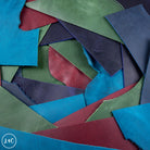  various leather off cuts of blue, green, and red.
