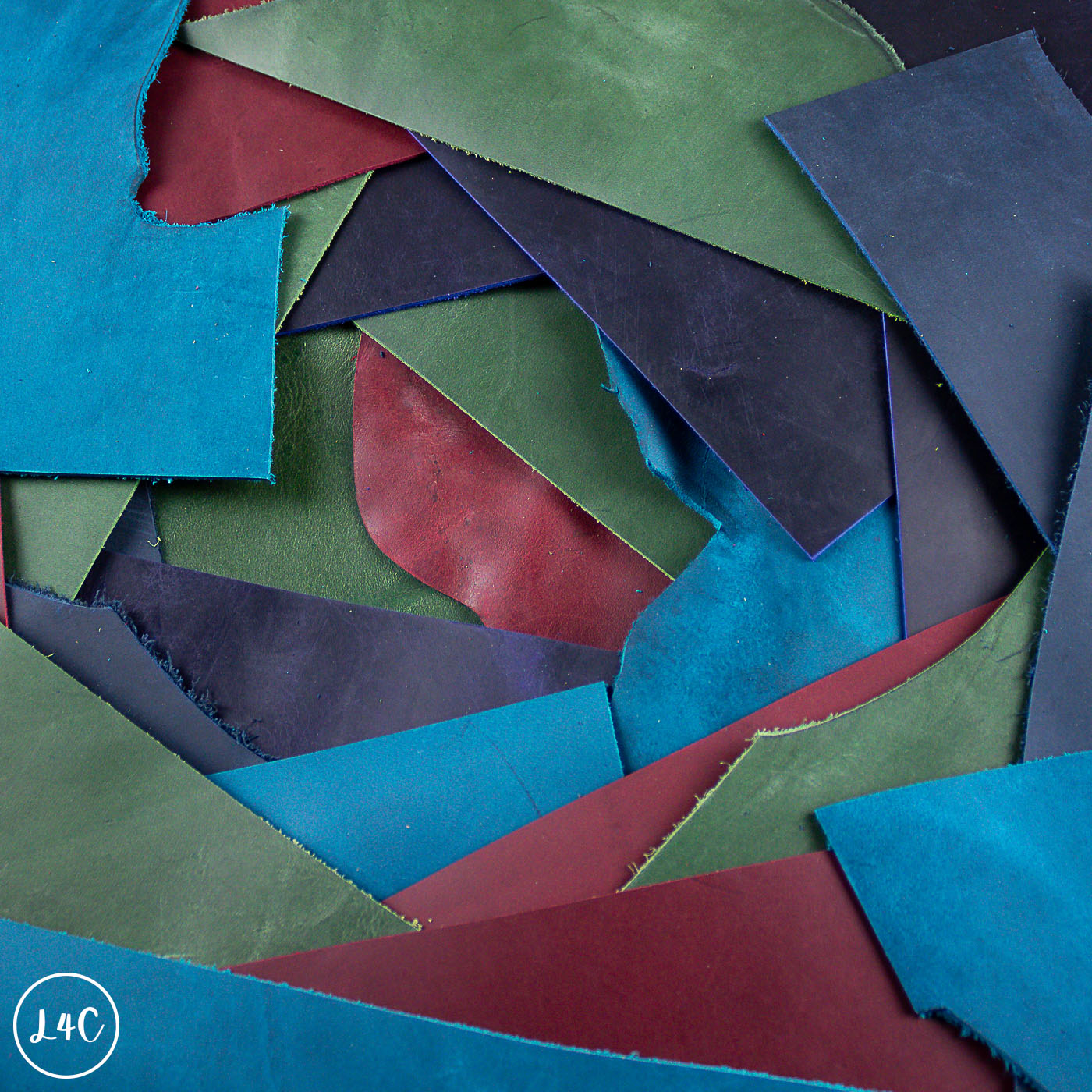  various leather off cuts of blue, green, and red.